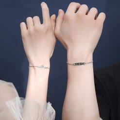 a pair of hands with bracelets