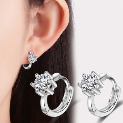 a pair of earrings with diamonds